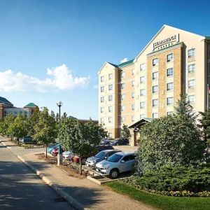 Hotel exterior with parking area at Staybridge Suites Oakville-Burlington.