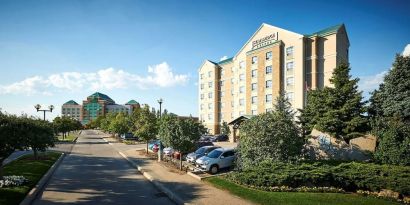 Hotel exterior with parking area at Staybridge Suites Oakville-Burlington.