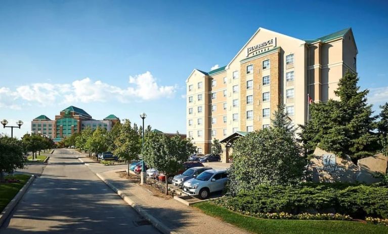 Hotel exterior with parking area at Staybridge Suites Oakville-Burlington.