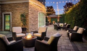 Outdoor patio with lounge seating and fireplace  at Staybridge Suites Oakville-Burlington.