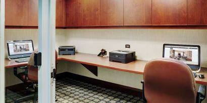 Business center with computers, printers and ergonomic chairs at Staybridge Suites Oakville-Burlington.