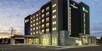 Hotel exterior and parking area at Holiday Inn Express Kingston West.