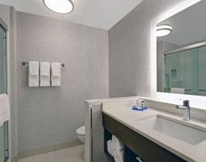 Private guest bathroom with shower and free toiletries at Holiday Inn Express Kingston West.