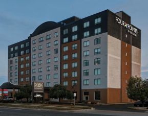 Hotel exterior and parking area at Four Points By Sheraton Toronto Mississauga.