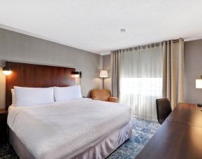 Day use room with TV, sofa, work desk and private bathroom at Four Points By Sheraton Toronto Mississauga.