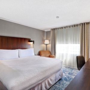 Day use room with TV, sofa, work desk and private bathroom at Four Points By Sheraton Toronto Mississauga.