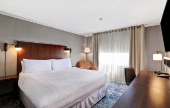 Day use room with TV, sofa, work desk and private bathroom at Four Points By Sheraton Toronto Mississauga.