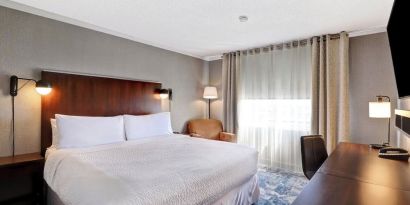 Day use room with TV, sofa, work desk and private bathroom at Four Points By Sheraton Toronto Mississauga.