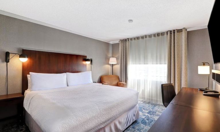 Day use room with TV, sofa, work desk and private bathroom at Four Points By Sheraton Toronto Mississauga.