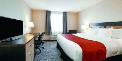 Day use room with TV, sofa, work desk and private bathroom at Quality Inn & Suites Kingston.