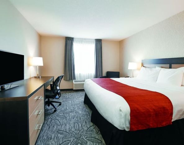 Day use room with TV, sofa, work desk and private bathroom at Quality Inn & Suites Kingston.