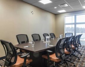 Professional meeting room with large windows and ergonomic chairs at Quality Inn & Suites Kingston.