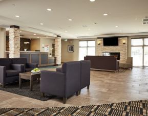 Hotel lobby with lounge area at Quality Inn & Suites Kingston.