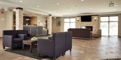 Hotel lobby with lounge area at Quality Inn & Suites Kingston.