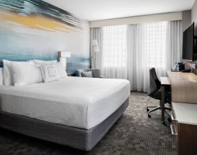 Day use room with TV, work desk and private bathroom at Courtyard By Marriott Edmonton Downtown.