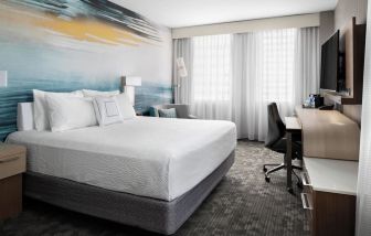 Day use room with TV, work desk and private bathroom at Courtyard By Marriott Edmonton Downtown.