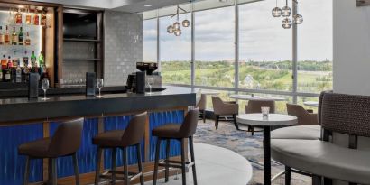 Hotel bar with lounge area at Courtyard By Marriott Edmonton Downtown.