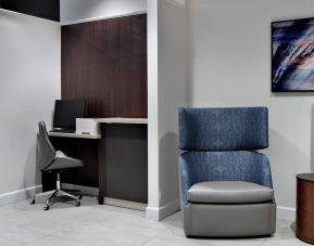 Business center with computer, printer and ergonomic chair at Courtyard By Marriott Edmonton Downtown.