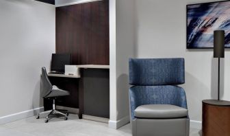 Business center with computer, printer and ergonomic chair at Courtyard By Marriott Edmonton Downtown.