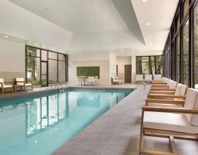 Relaxing indoor pool with lounge chairs at DoubleTree By Hilton Hotel Toronto Airport West.