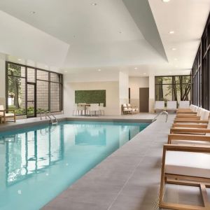 Relaxing indoor pool with lounge chairs at DoubleTree By Hilton Hotel Toronto Airport West.