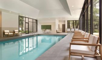 Relaxing indoor pool with lounge chairs at DoubleTree By Hilton Hotel Toronto Airport West.