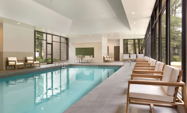 Relaxing indoor pool with lounge chairs at DoubleTree By Hilton Hotel Toronto Airport West.