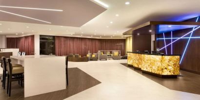 Hotel lobby with lounge area and work space at DoubleTree By Hilton Hotel Toronto Airport West.
