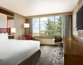 Day use room with large windows, TV, sofa, work desk and private bathroom at DoubleTree By Hilton Hotel Toronto Airport West.