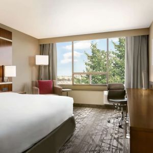 Day use room with large windows, TV, sofa, work desk and private bathroom at DoubleTree By Hilton Hotel Toronto Airport West.