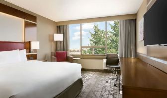 Day use room with large windows, TV, sofa, work desk and private bathroom at DoubleTree By Hilton Hotel Toronto Airport West.