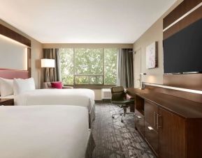 Day use twin room with large windows, TV, sofa, work desk and private bathroom at DoubleTree By Hilton Hotel Toronto Airport West.