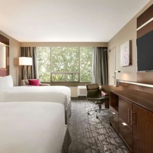 Day use twin room with large windows, TV, sofa, work desk and private bathroom at DoubleTree By Hilton Hotel Toronto Airport West.