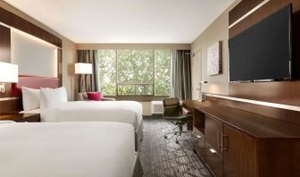 Day use twin room with large windows, TV, sofa, work desk and private bathroom at DoubleTree By Hilton Hotel Toronto Airport West.