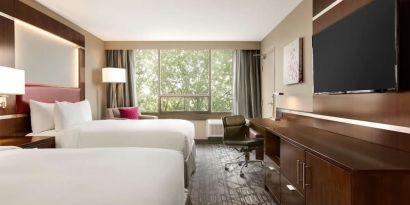 Day use twin room with large windows, TV, sofa, work desk and private bathroom at DoubleTree By Hilton Hotel Toronto Airport West.