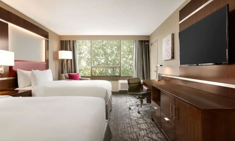 Day use twin room with large windows, TV, sofa, work desk and private bathroom at DoubleTree By Hilton Hotel Toronto Airport West.