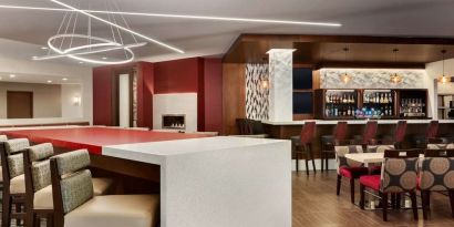 Stylish hotel bar with comfortable seating at DoubleTree By Hilton Hotel Toronto Airport West.