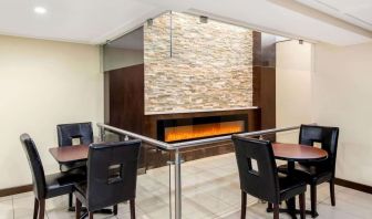 Dining area with fireplace at La Quinta Inn & Suites By Wyndham Oshawa.