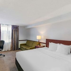 Day use room with TV, sofa, work desk and private bathroom at Quality Hotel & Suites Montreal East.