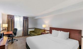 Day use room with TV, sofa, work desk and private bathroom at Quality Hotel & Suites Montreal East.