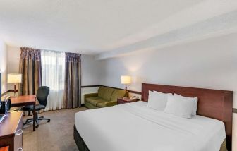 Day use room with TV, sofa, work desk and private bathroom at Quality Hotel & Suites Montreal East.