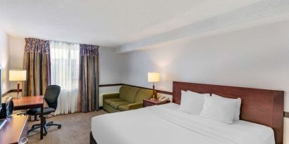 Day use room with TV, sofa, work desk and private bathroom at Quality Hotel & Suites Montreal East.