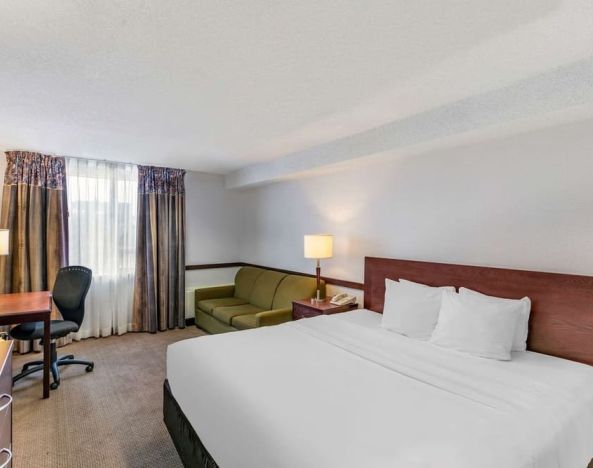 Day use room with TV, sofa, work desk and private bathroom at Quality Hotel & Suites Montreal East.