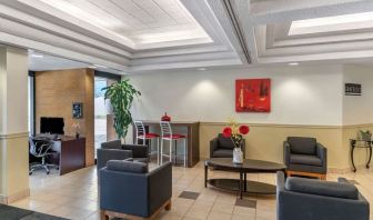 Hotel lobby with lounge area and work station at Quality Hotel & Suites Montreal East.