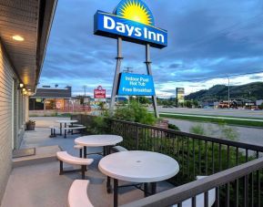 Hotel exterior with sitting area at Days Inn Vernon.