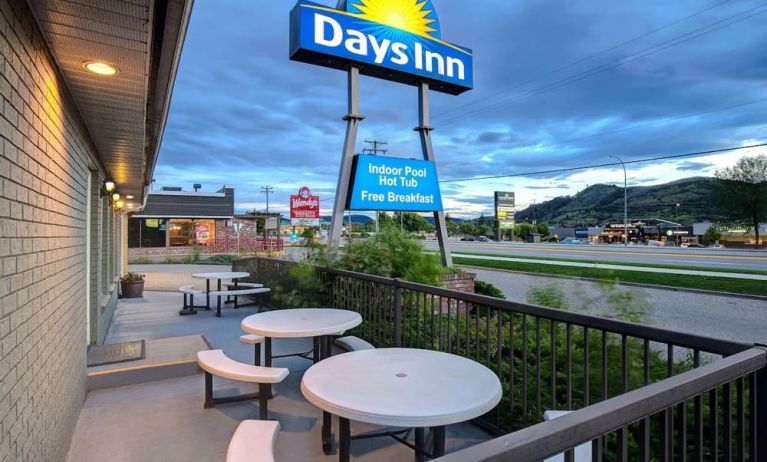 Hotel exterior with sitting area at Days Inn Vernon.