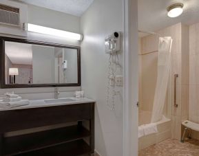 Private guest bathroom with shower and free toiletries at Days Inn Vernon.