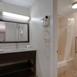 Private guest bathroom with shower and free toiletries at Days Inn Vernon.