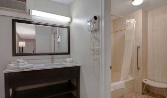 Private guest bathroom with shower and free toiletries at Days Inn Vernon.