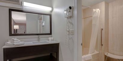 Private guest bathroom with shower and free toiletries at Days Inn Vernon.